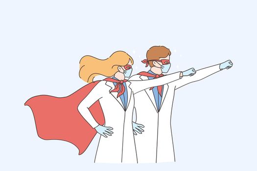 Superpower of doctors during coronavirus pandemic concept. Man and woman doctors medical workers wearing surgical face mask in superhero costume standing and raising hands up