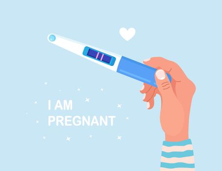 Beautiful female hand is holding a pregnancy or ovulation test with positive result as a two lines. Pregnant woman waiting childbirth. Planning a baby, motherhood and healthcare concept