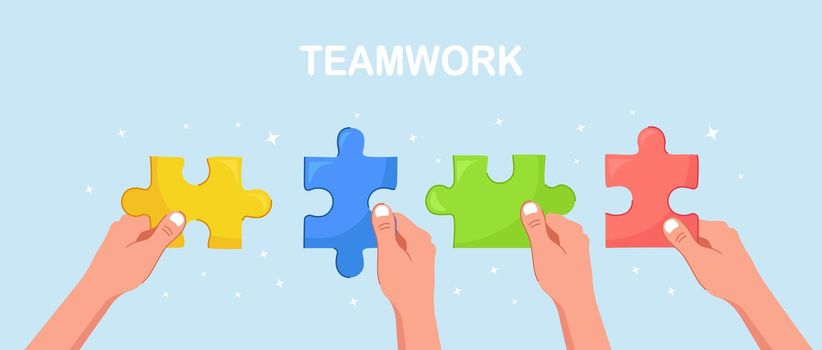 Businessmen hold in hands  the pieces of jigsaw puzzle and connect it. Team work business metaphor. Teamwork, success concept