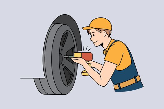 Repairing and working with cars concept. Young man worker repairman mechanic in uniform and cap fixing and working with cars wheel with drill vector illustration