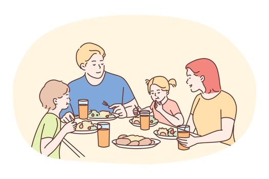 Happy family having dinner or breakfast together at home. Smiling family father mother and children cartoon characters sitting and eating healthy meal at table together at home. Clean homemade eating
