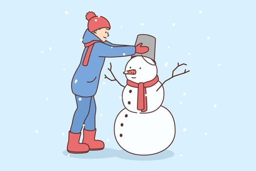 Happy kid in outerwear building snowman in winter outdoors. Smiling boy child have fun decorate frosty figure outside. Vector illustration.