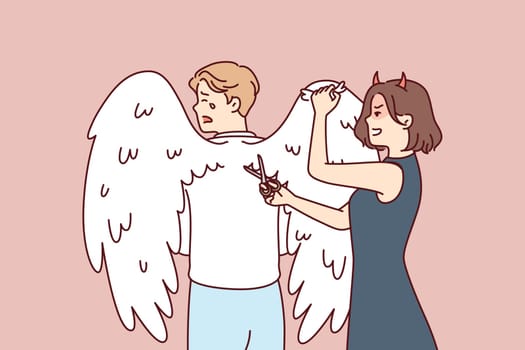 Woman with clipping wings on back crying man to limit freedom and potential. Girl with demon horns brings scissors to back of angel for concept totalitarian environment in company