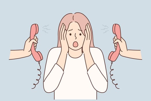 Woman is nervous about lot of phone calls and intrusive telemarketing or spam. Girl clutches head stands among telephone handsets for concept of problems with multitasking and overload at work