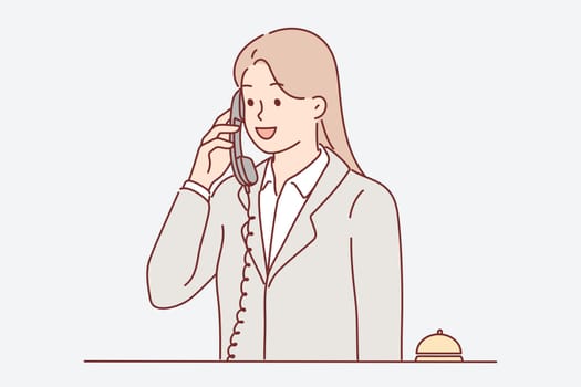 Receptionist woman talking on phone answering customer call with request to send maid or waiter. Receptionist girl works in hotel helping guests feel comfortable and makes career in field of HoReCa