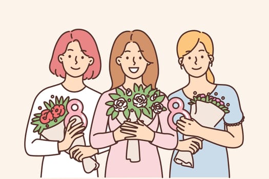 Female with bouquets of flowers presented in honor of International Womens Day and number eight in hands. Happy girls with flowers looking at camera enjoying womens day celebration