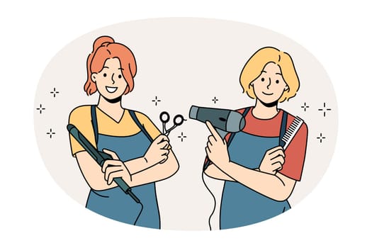 Working as hairdresser in salon concept. Two young smiling girls wearing aprons standing holding working tools in hairdressing salon vector illustration