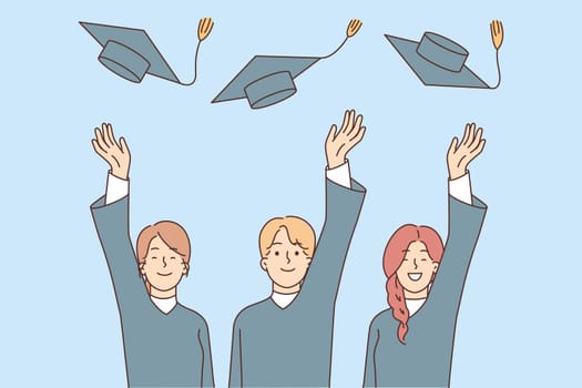 Graduates toss hats after graduation from university or college and celebrate receiving in-demand profession. Happy graduates students wearing academic gown rejoicing at elite education