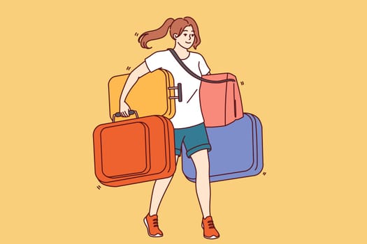 Woman carries lot of tourist suitcases when going on long trip or changing places of residence. Girl with heavy suitcases walks and smiles for concept immigration and change country