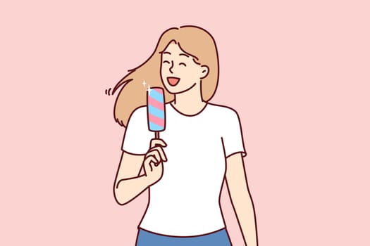 Woman eats ice cream to cool off in hot summer weather and enjoy cold sweet dessert. Young girl in casual clothes holds ice cream and smiles enjoying treat that relieves thirst and hunger.