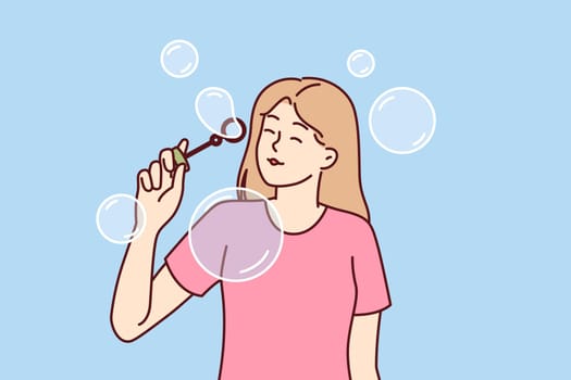 Teenager girl blows soap bubbles enjoying presence free time and absence of urgent matters. Carefree schoolgirl teen stands among soap bubbles and is too lazy to do extracurricular work
