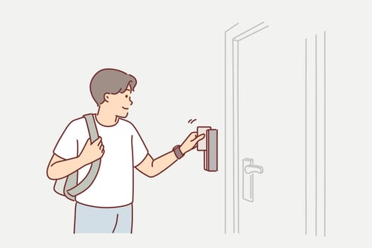 Man uses key card to open door to hotel room or hostel during tourist trip or business trip. Guy with key card opens electronic lock, gaining access to back office for company employees.