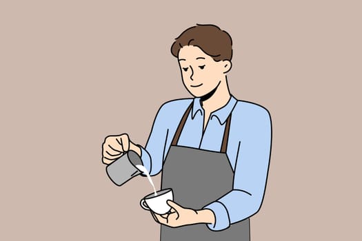 Man barista prepares delicious coffee with fresh cream, working in trendy coffee shop or restaurant. Barista guy pours milk into mug of cappuccino, which gives energy due to its caffeine content.