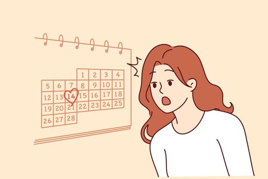 Woman learns about valentine day on february 14th and feels shocked, standing near wall with calendar. Girl forgot about approach of valentine day does not know where to get gift for boyfriend
