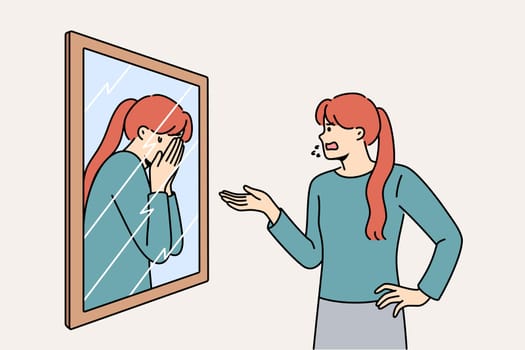 Woman scolds own reflection in mirror, for concept of low self-esteem and problems with having self-confidence. Split personality and lack of self-esteem causes disorder or nervous breakdowns
