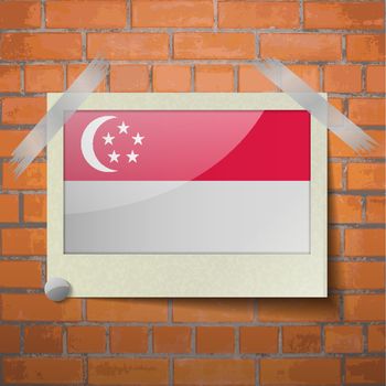 Flags of Singapore scotch taped to a red brick wall. Vector