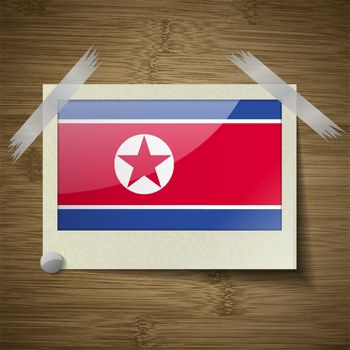Flags of Korea North at frame on wooden texture. Vector illustration