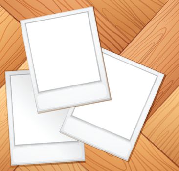 Blank photo frames on the wooden background