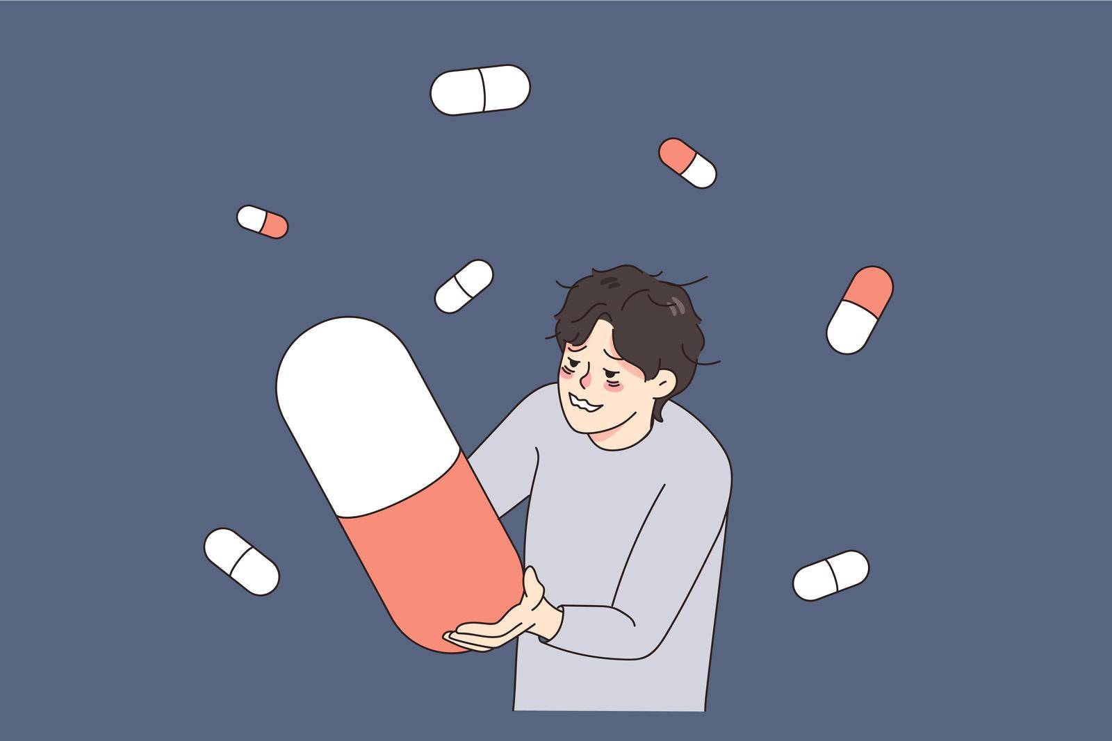 Unhappy stressed man suffer from drug addiction hold huge pill. Upset unhealthy guy struggle with depression addicted to medication and tablets. Medicine and healthcare. Vector illustration.