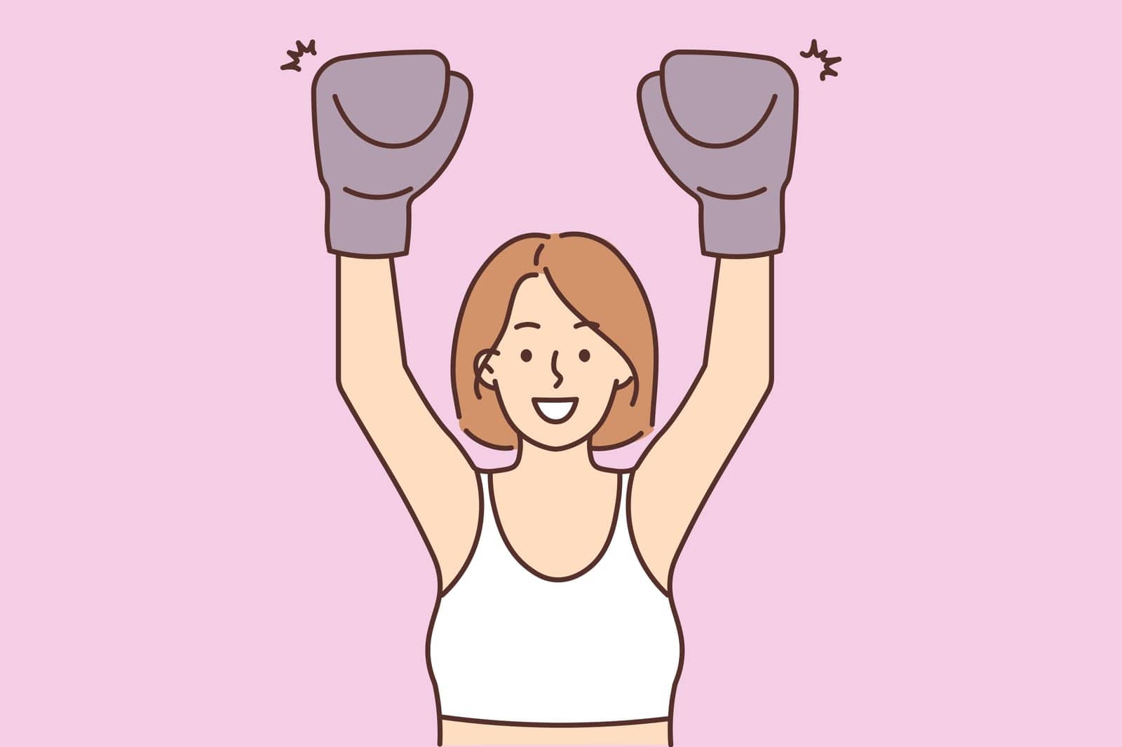 Smiling woman in boxing gloves training by Vasilyeu