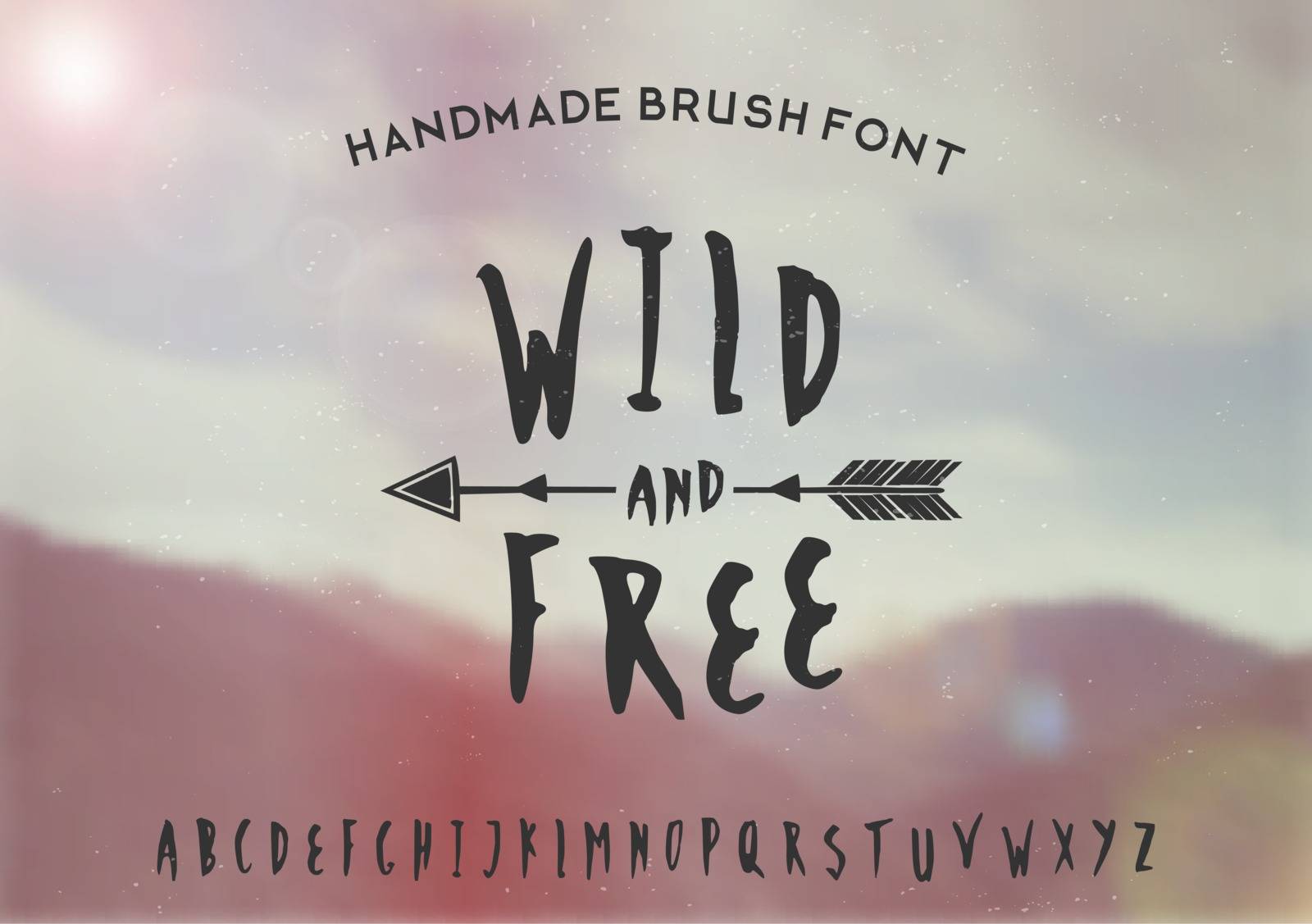 Hand drawn brush font on a blurred vintage style mountain view background. EPS 10 file, gradient mesh and transparency effects used.